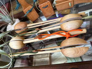 Neil's Wood Shop Toys with strings on a glass surface.