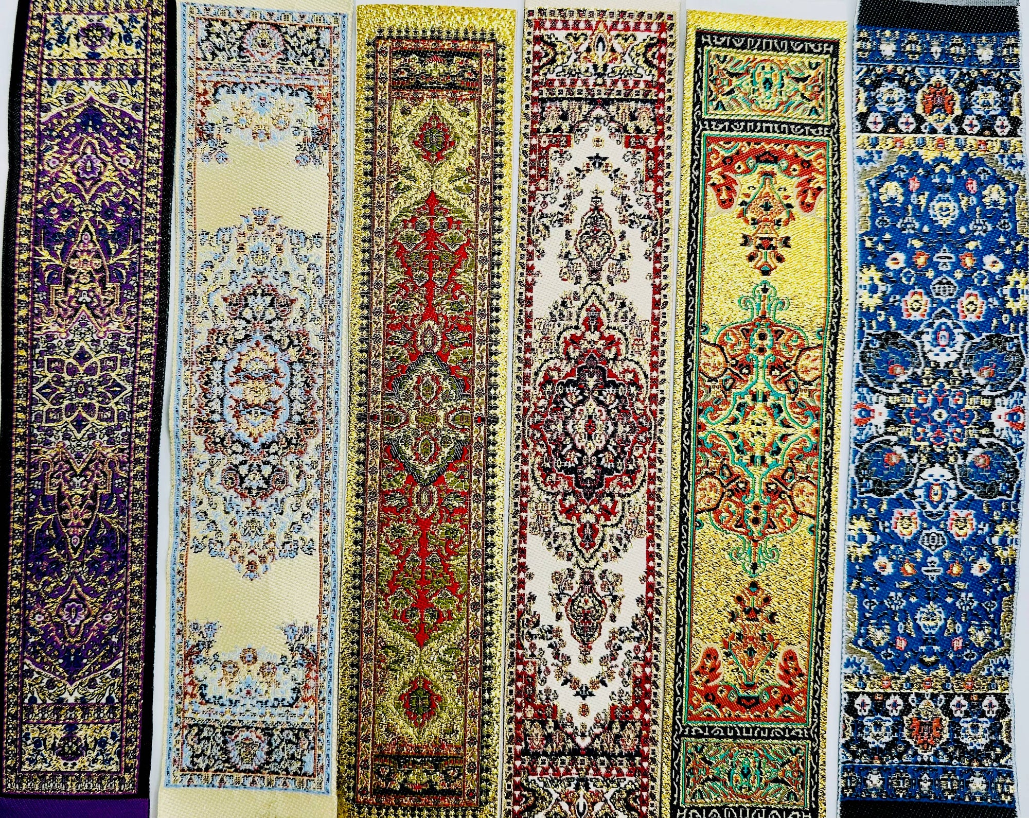 A display of various intricate, colorful, individually packaged Turkish Bookmarks featuring traditional patterns typically found in Turkish carpet designs.