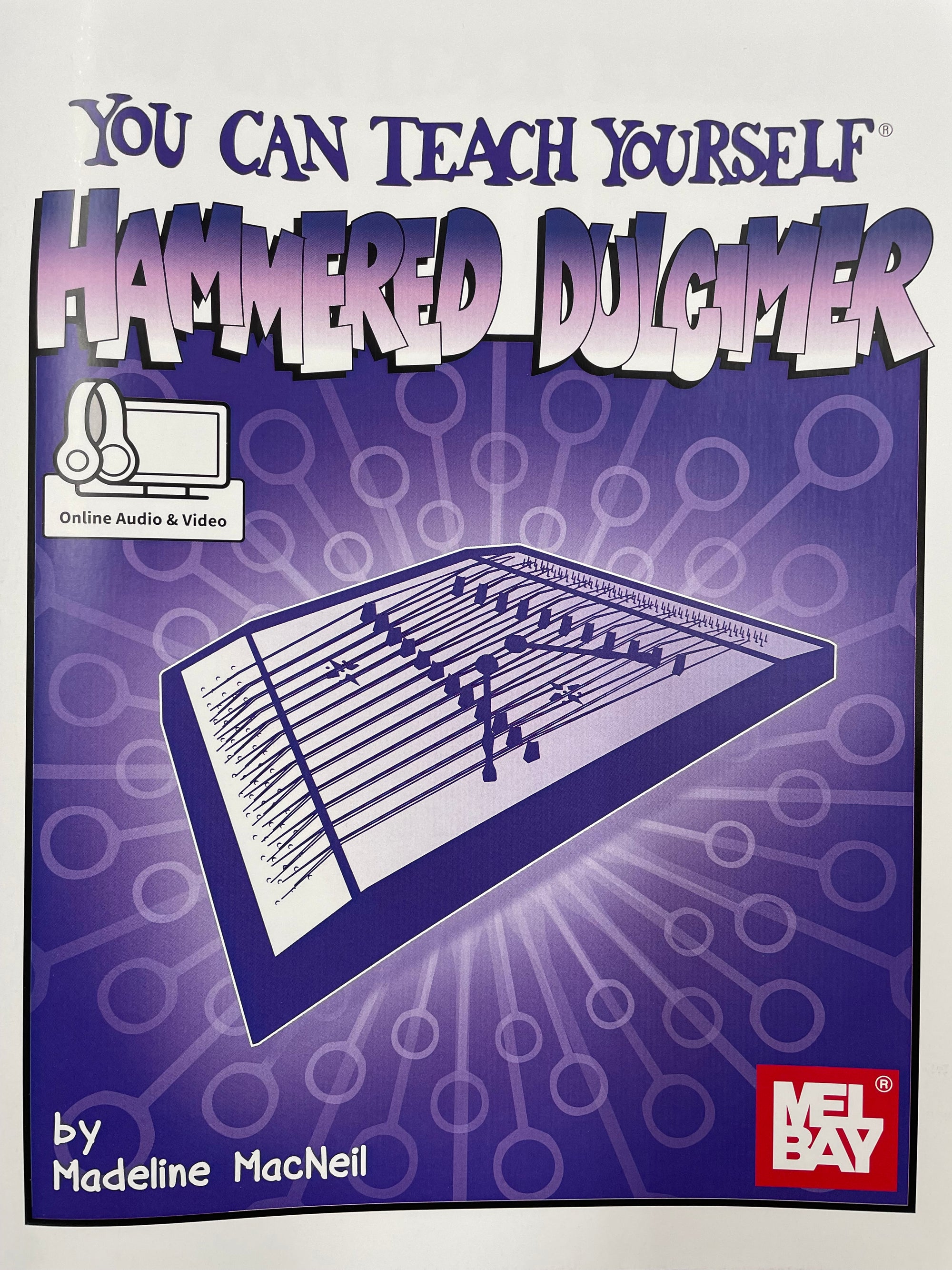 Sentence with product name: A beginning book cover for "You Can Teach Yourself Hammered Dulcimer" by Madeline MacNeil, featuring an illustration of the You Can Teach Yourself Hammered Dulcimer with musical notes and access to online audio.