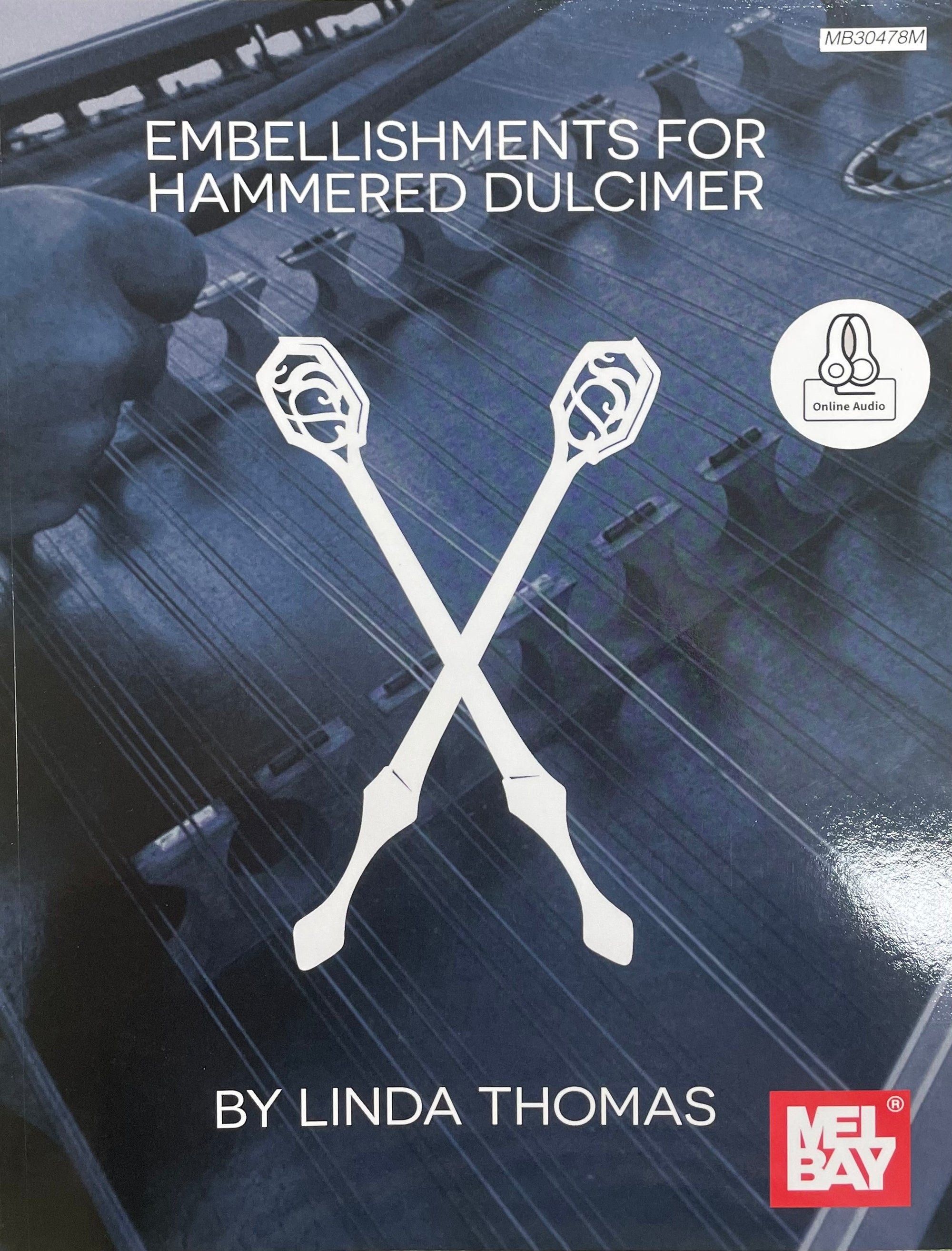 Cover of the book "Embellishments for Hammered Dulcimer by Linda Thomas," featuring two crossed dulcimer hammers, decorative embellishments, and the Mel Bay logo at the bottom right corner.
