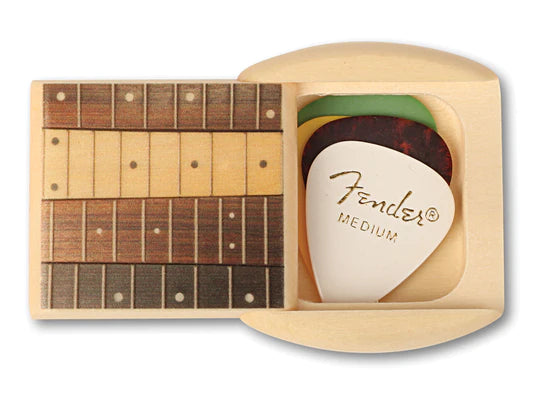 A Treasure Box Aspen Secret Box - Includes 4 Guitar Picks, styled to look like a Fender medium-sized pick, is elegantly displayed with guitar fretboard-designed coasters, arranged as prized trinkets.