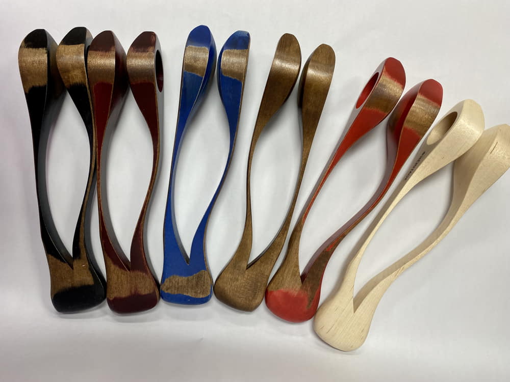 A row of Heritage Musical Spoons Large, evoking a sense of heritage, arranged in order from dark to light shades.