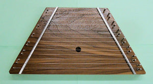 A Lap Harp Walnut, a wooden acoustic folk instrument, with metal wires on it.
