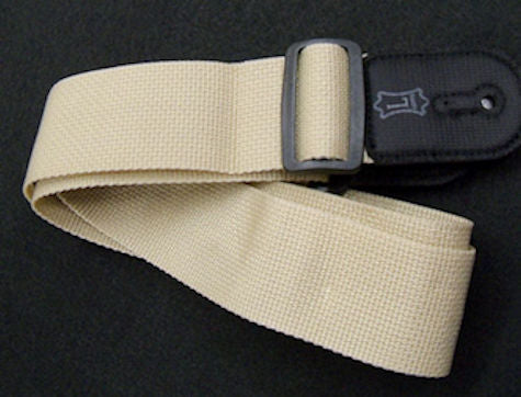 A Nylon Strap - Tan with an adjustable buckle.