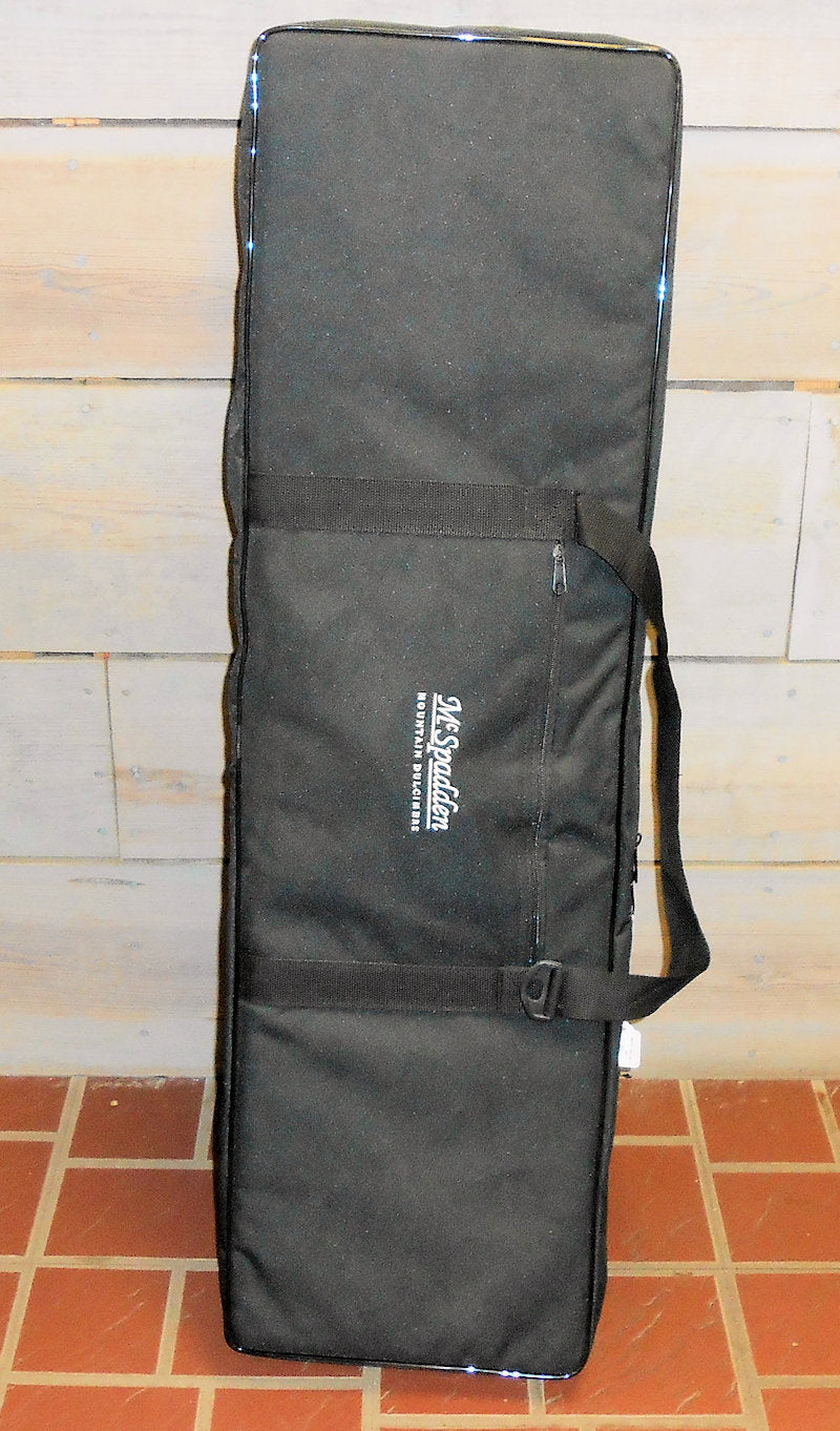 A black nylon Pro (Foam Core) Case with a strap sitting on a brick floor.
