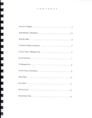Table of contents from "Merry Christmas by Linda Thomas" listing Christmas songs for the hammered dulcimer with page numbers, including titles like "Away In A Manger" and "Silent Night.