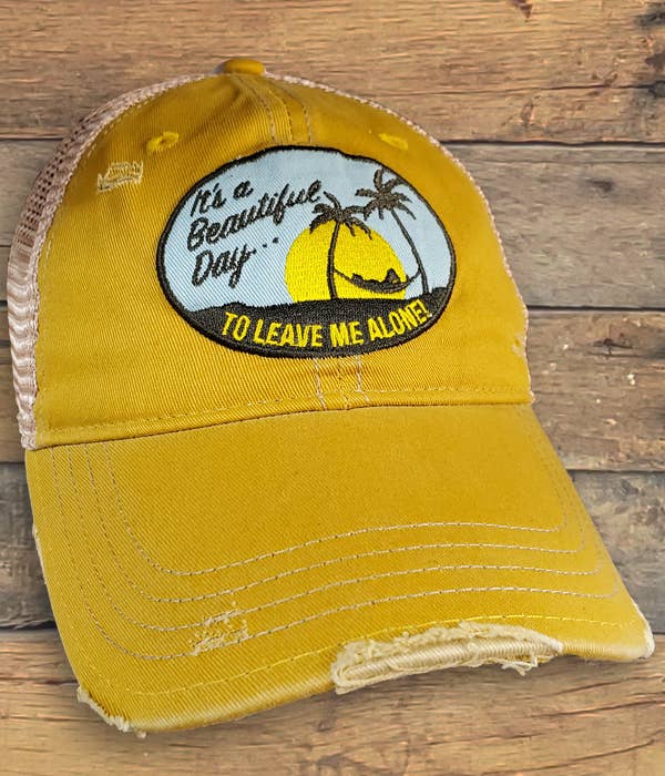 A Beautiful Day Hat with a palm tree on it. This trucker cap combines vibrant yellow color and features a stylish palm tree design. It also includes a convenient snap back closure for an easy fit.