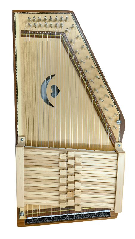 A wooden autoharp with metal strings, tuning pegs, and chord bars on top, photographed against a plain white background.