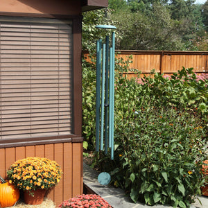 A peaceful retreat in a backyard garden with a Corinthian Bells® 74-inch Windchime.