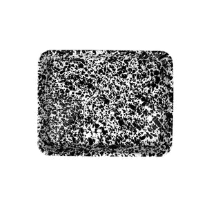 The Splatter Enamelware Small Rectangular Tray boasts a black and white splatter pattern against a white background, all with a durable porcelain finish.