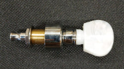 Close-up of an Individual Planetary Tuning Peg - Scroll, featuring a white plastic button and metallic shaft, resting on a textured black surface.
