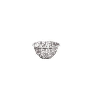 The Splatter Enamelware Small Footed Bowl features a white and gray speckled pattern and is perfect for serving dip. Isolated on a white background, this versatile 16 oz bowl from our enamelware collection adds charm to any table setting.