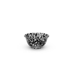 The Splatter Enamelware Small Footed Bowl, featuring a black and white speckled design with a rounded shape and flared rim, perfect for serving dip, is centered against a plain white background.