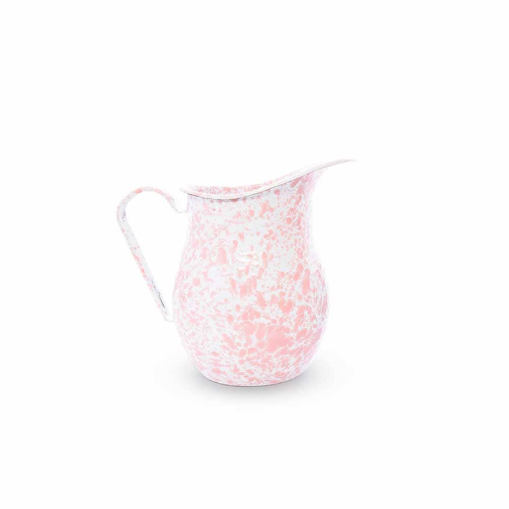 The Splatter Enamelware Large Pitcher, featuring a pink and white speckled design with a curved handle and spout, is perfect for entertaining a crowd.