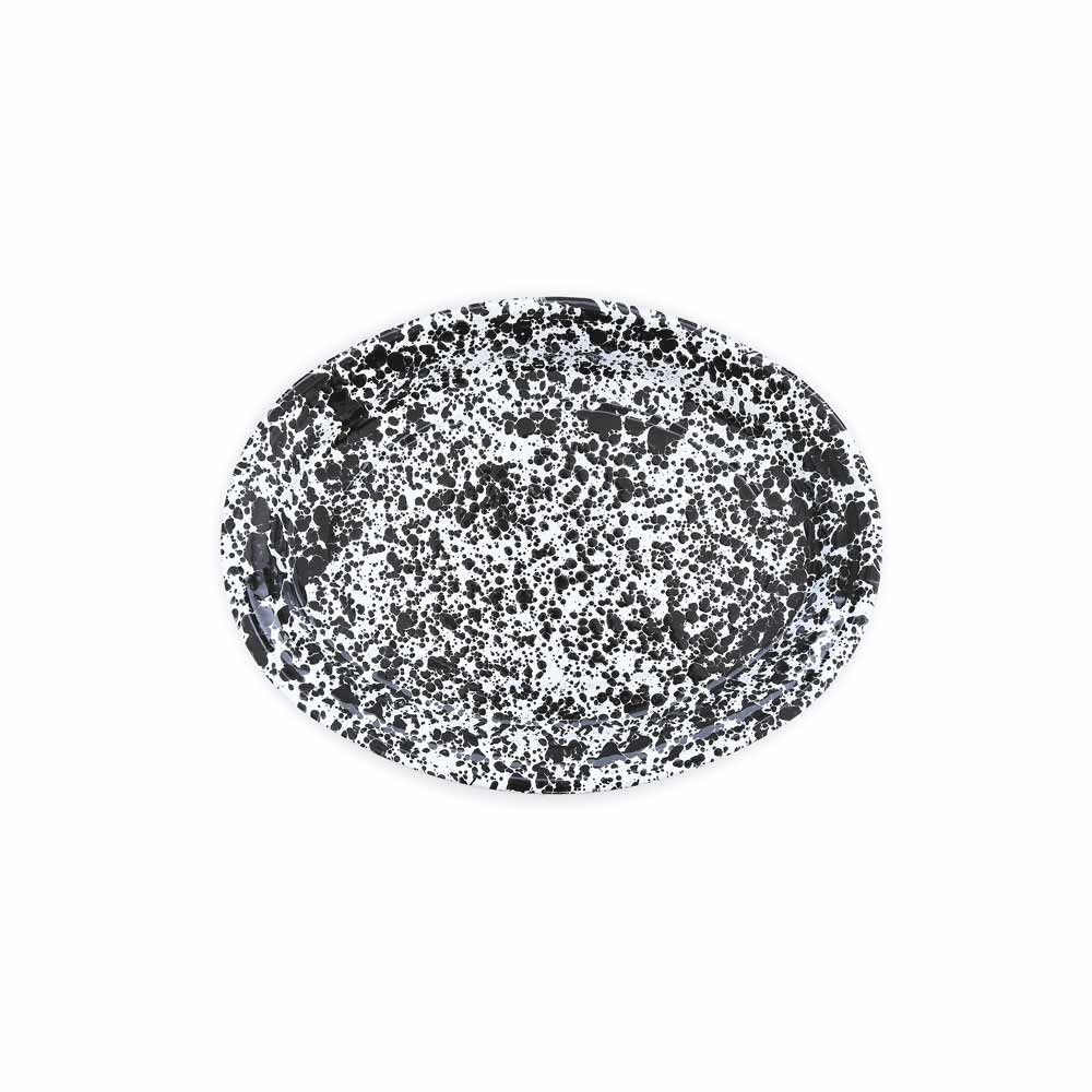 The Splatter Enamelware Oval Platter features a black and white splatter pattern on a white background, making it perfect for entertaining.