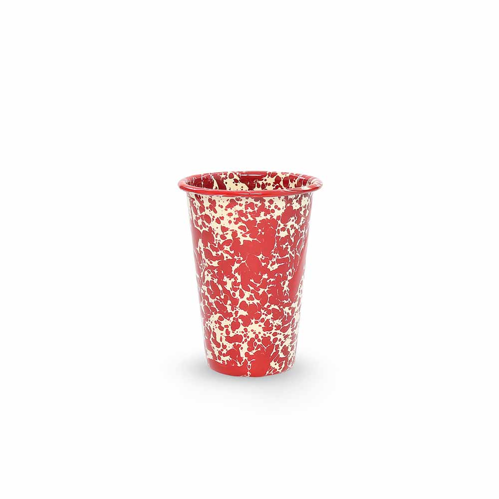 The Splatter Enamelware 14 oz Tumbler, showcasing a vibrant red and white speckled design, is featured against a plain white background. This charming piece is perfect for entertaining a crowd.