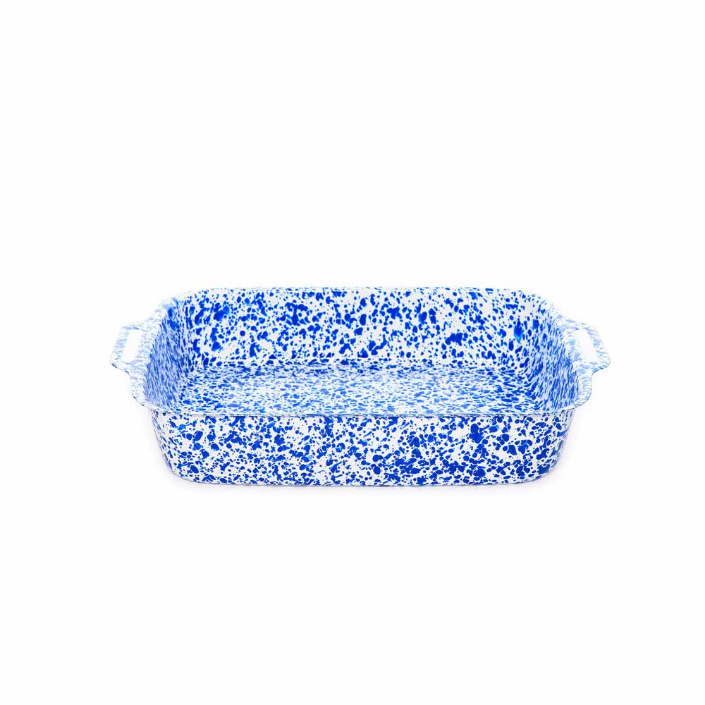 The Splatter Enamelware Lasagna Pan, featuring a durable porcelain finish and handles on both ends, is displayed against a white background in its rectangular blue and white speckled design.