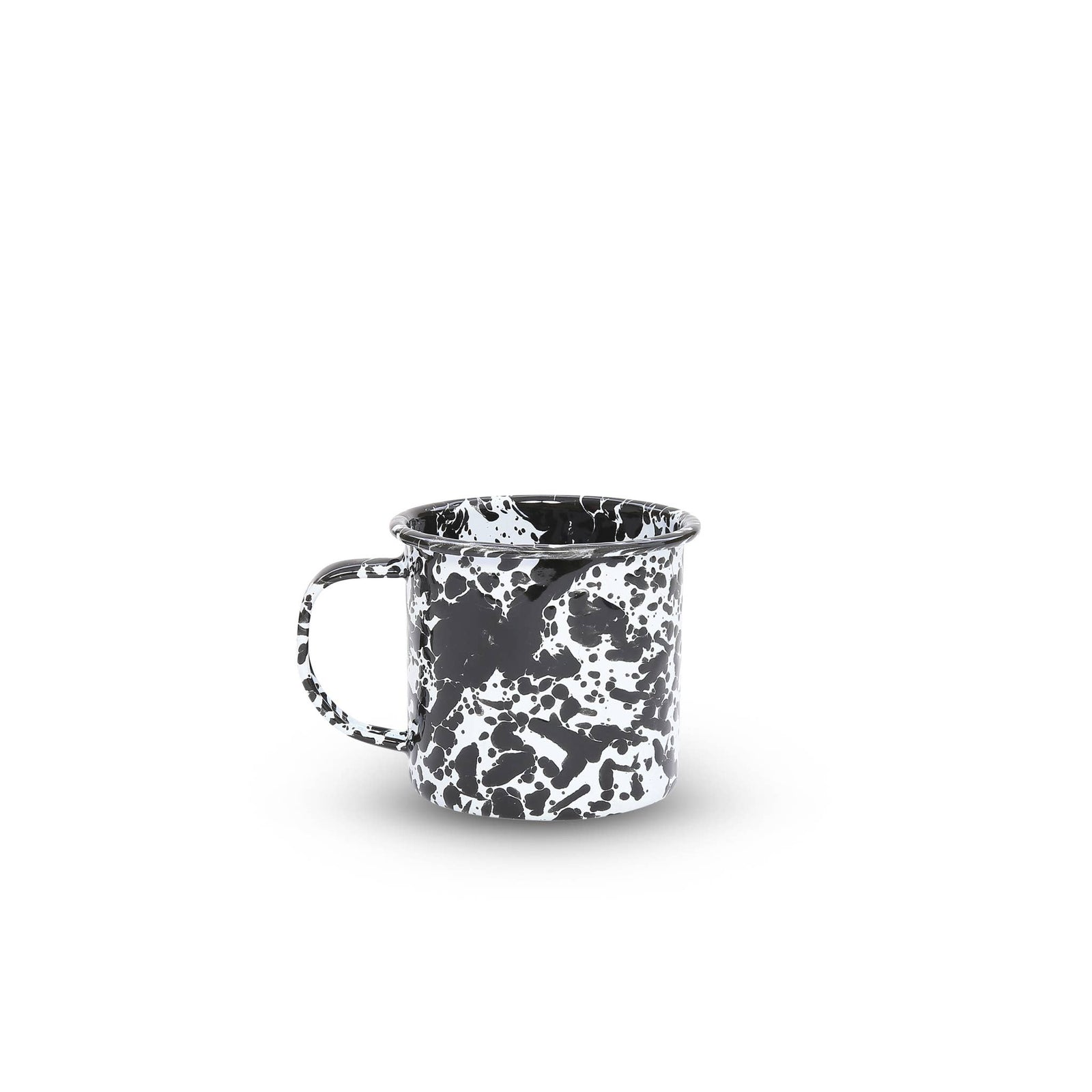 The Splatter Enamelware 12 oz Mug, featuring a charming black and white speckled design and a convenient handle, is perfect for entertaining a crowd on any occasion, all set against a pristine white background.