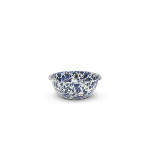 The Splatter Enamelware 20 oz Cereal Bowl, featuring a small blue and white speckled design, is perfect for entertaining a crowd or serving as a charming cereal bowl, set against a white background.