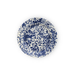 The Splatter Enamelware Dinner Plate features a round design with a white background and a vibrant blue splatter pattern, making it perfect for entertaining.