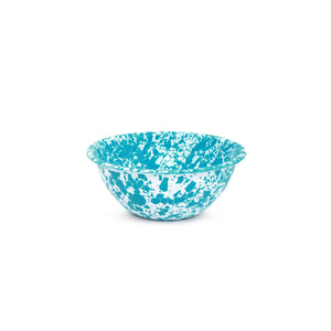 A Splatter Enamelware Small Serving Bowl, featuring a vibrant turquoise and white splatter pattern, is centered against a white background.