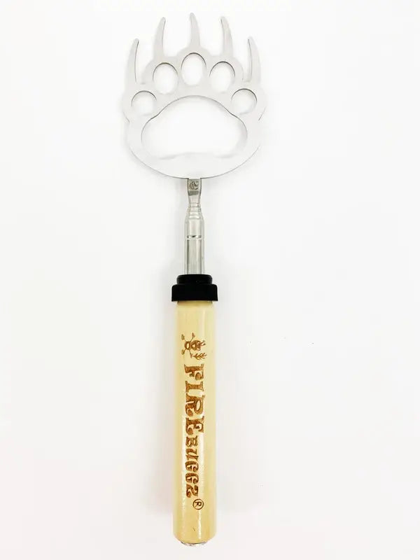 An extendable Reach N Roll Bear Claw back scratcher, featuring a wooden handle with the branding text "The Kruger," and a metal bear claw design at the scratching end for those hard-to-reach spots.