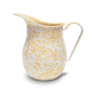 The Splatter Enamelware Large Pitcher, with its yellow and white speckled design, spout, and handle, is perfect for entertaining a crowd.