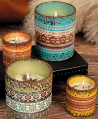 A group of colorful Boho Vibes Swan Creek Candle holders on a wooden table.