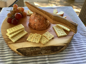 A handmade Cheeseball Board with Knife, featuring eco-consciousness, with crackers and grapes.