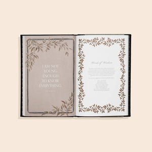 An open Grandpa's Story: A Memory and Keepsake Journal for My Family with a gold leaf design, perfect for writing prompts and preserving the cherished memories of grandpa.