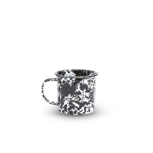 A Splatter Enamelware 12 oz mug in black and white with a handle, shown on a plain white background.