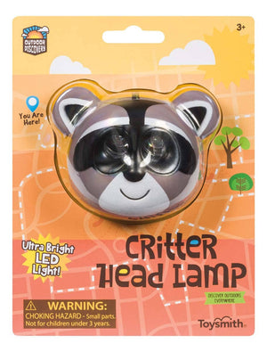 Packaging of a child's "Outdoor Discovery Critter Head Lamp" with raccoon design, featuring an adjustable elastic headband, labeled as an ultra-bright LED light, intended for outdoor activities, recommended for