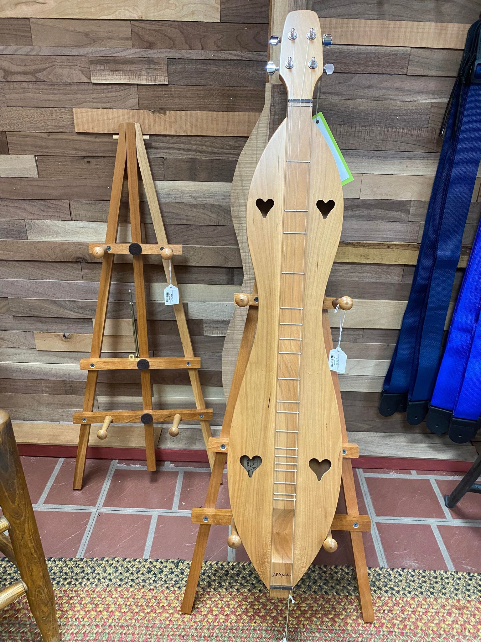 A wooden Dulcimer Stand is on display in a store.