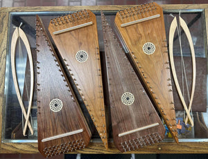 Four innovative Master Works Bowed Psaltery on display in a glass case.