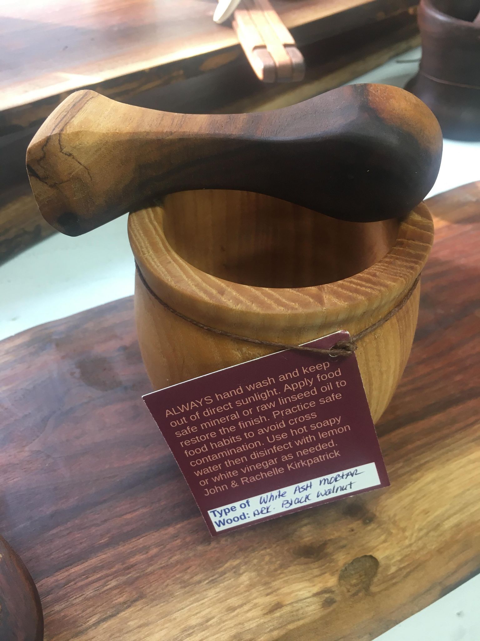 A handmade wooden Mortar and Pestles, a culinary tool, on display.
