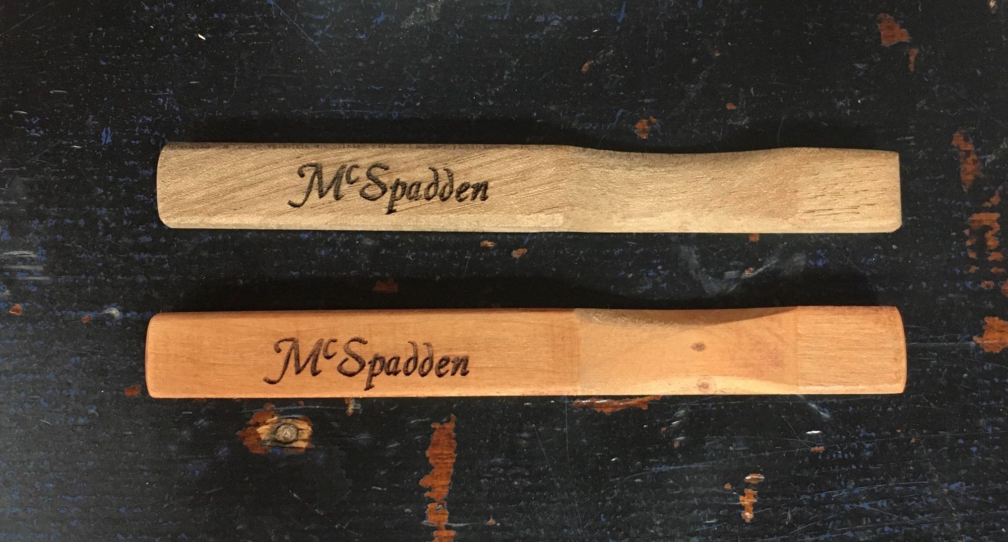 Two McSpadden Noters, one in walnut and one in ebony, engraved with the name Mr. Speelman.