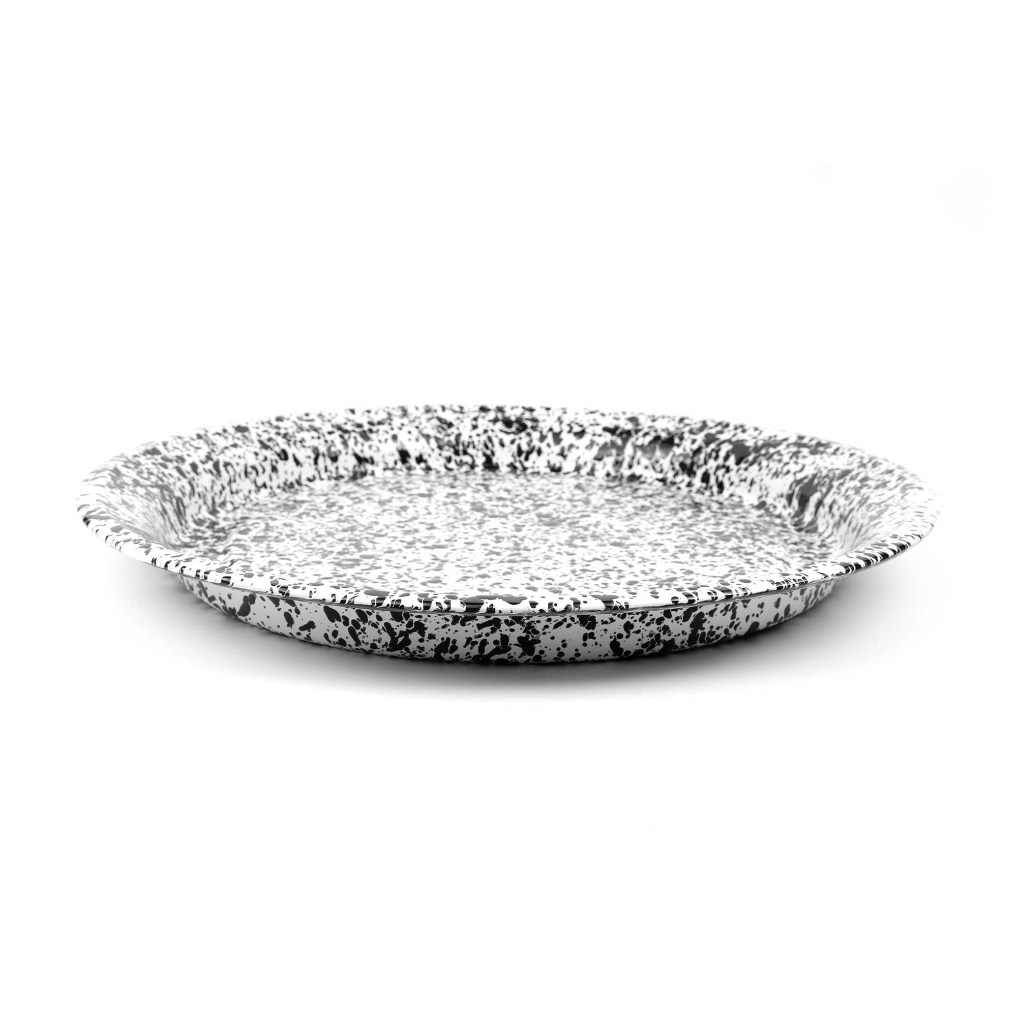 The Splatter Enamelware Large Round Tray, featuring a speckled white and black design with a slightly raised rim on a plain white background, is perfect for entertaining.