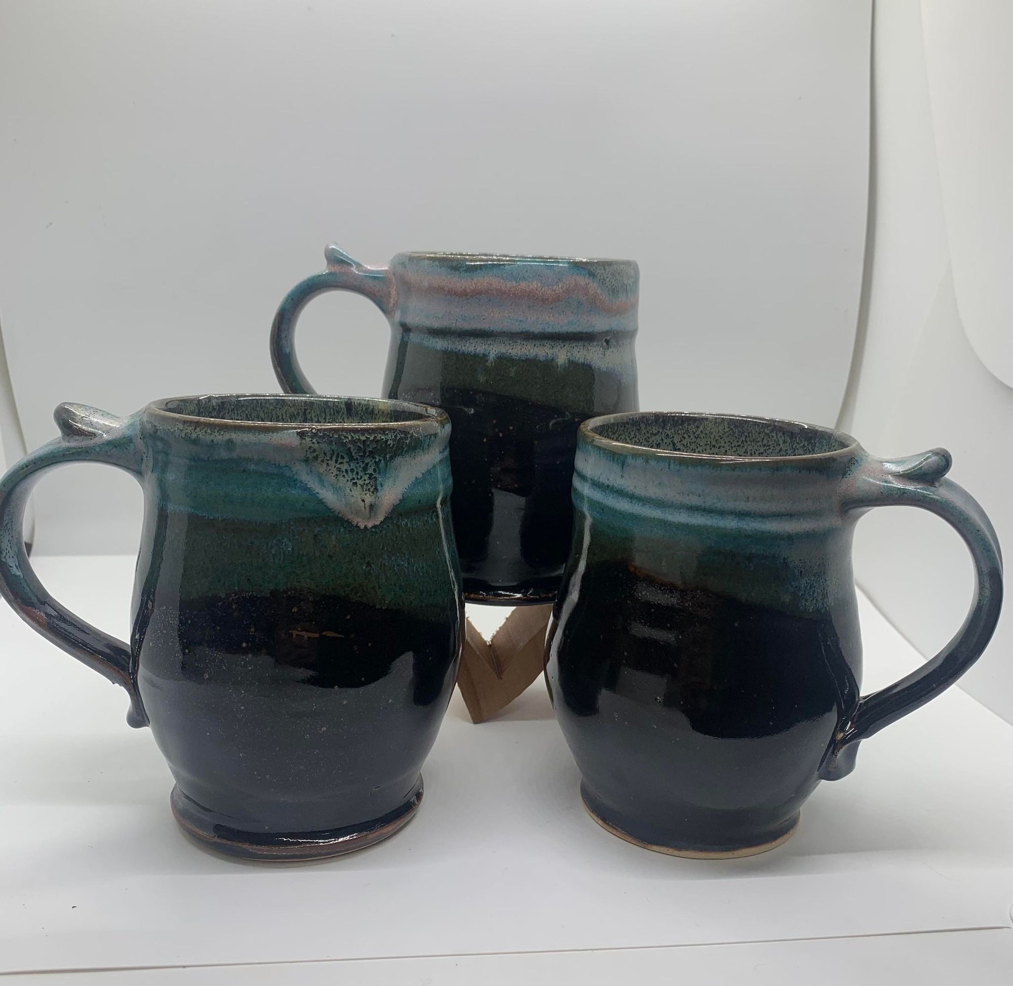 Three Perry Munn Pottery mugs sold as a set, sitting on a table.