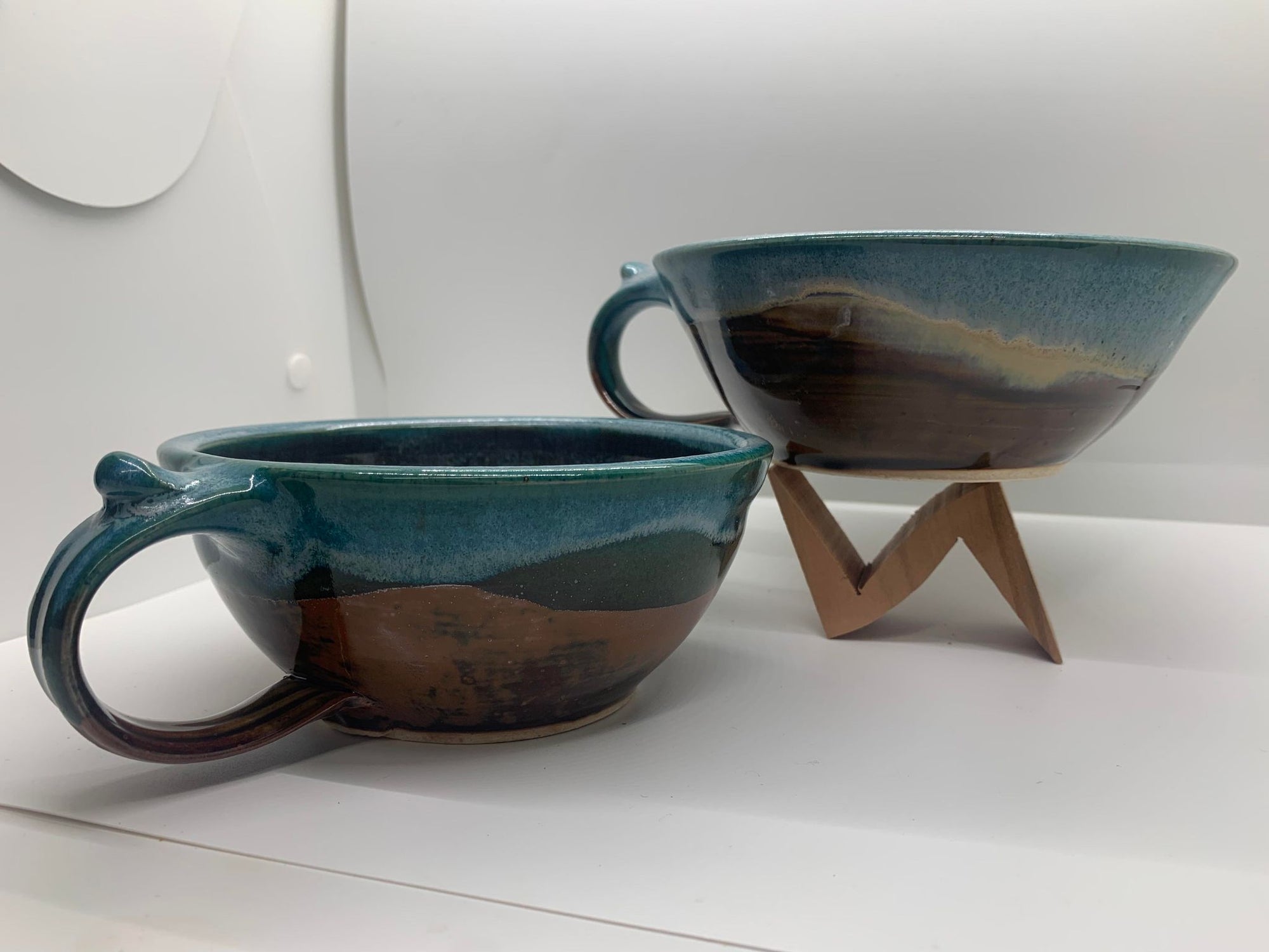 Two Perry Munn Pottery Soup Bowls on a tumbler stand.