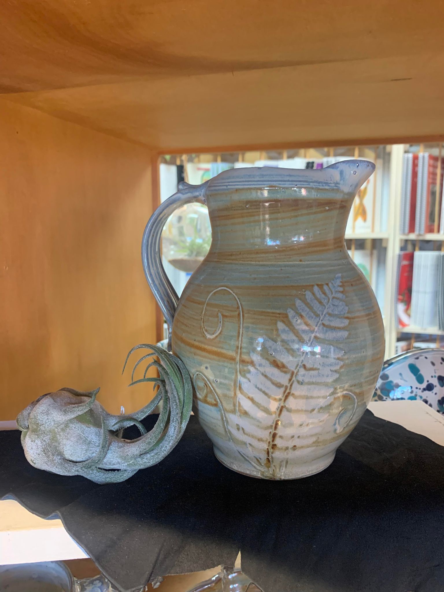 A Perry Munn Pottery Fern Pitcher adorned with delicate ferns.