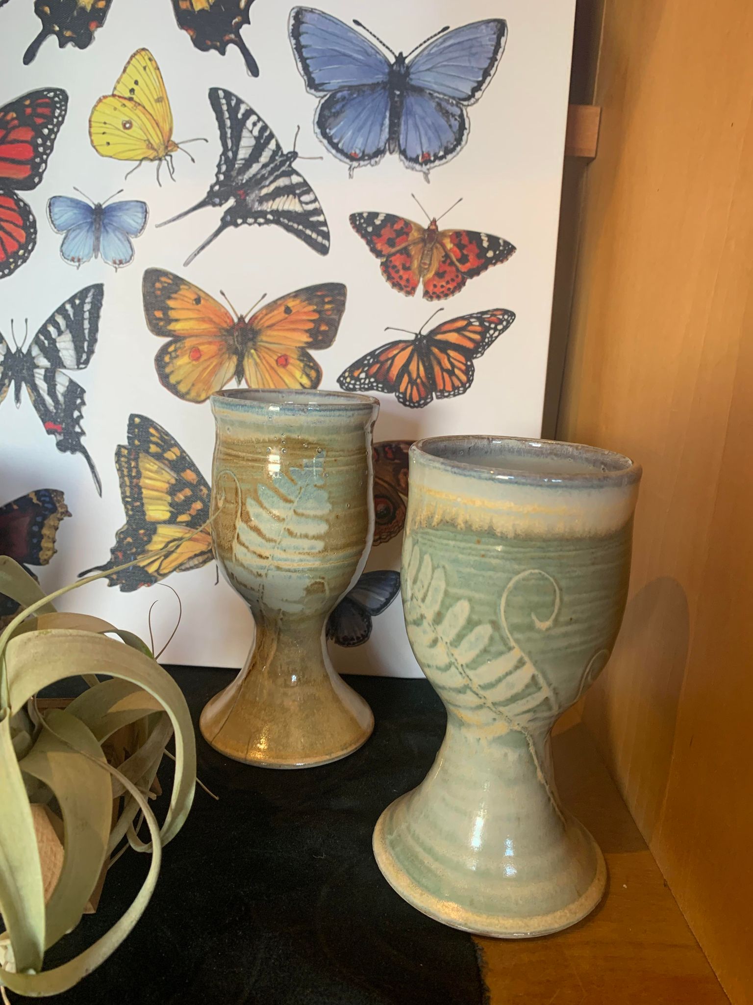 Set of two Perry Munn Pottery Fern Chalice adorned with ferns and butterflies.