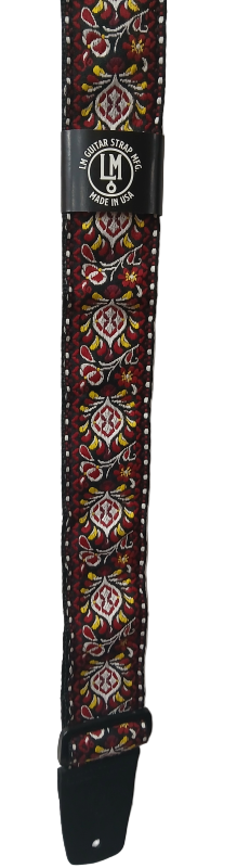 The Electric Red Guitar Strap features intricate red, yellow, and white designs with black leather ends and a "LM Guitar Strap Inc. Made in USA" label—ideal for guitar or dulcimer players who want standout style.