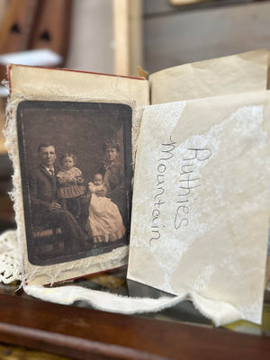 A Mrs. Pat's Junk Journal with a photo of a family sitting on top of it, featuring a local artist's touch.