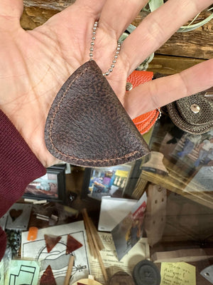 A person is holding a Handcrafted Leather Pick Pack in their hand, an elegant storage solution.