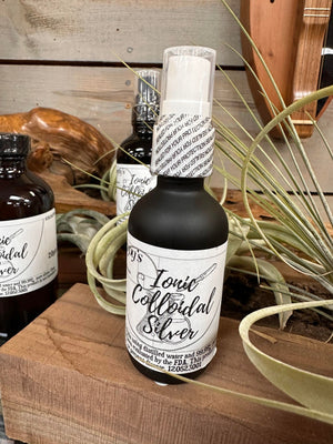 A locally made bottle of Colloidal Silver sitting on top of a wooden board.