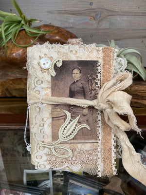 A photo of a woman, tied to Mrs. Pat's Junk Journals, captured by a local artist in Mountain View.