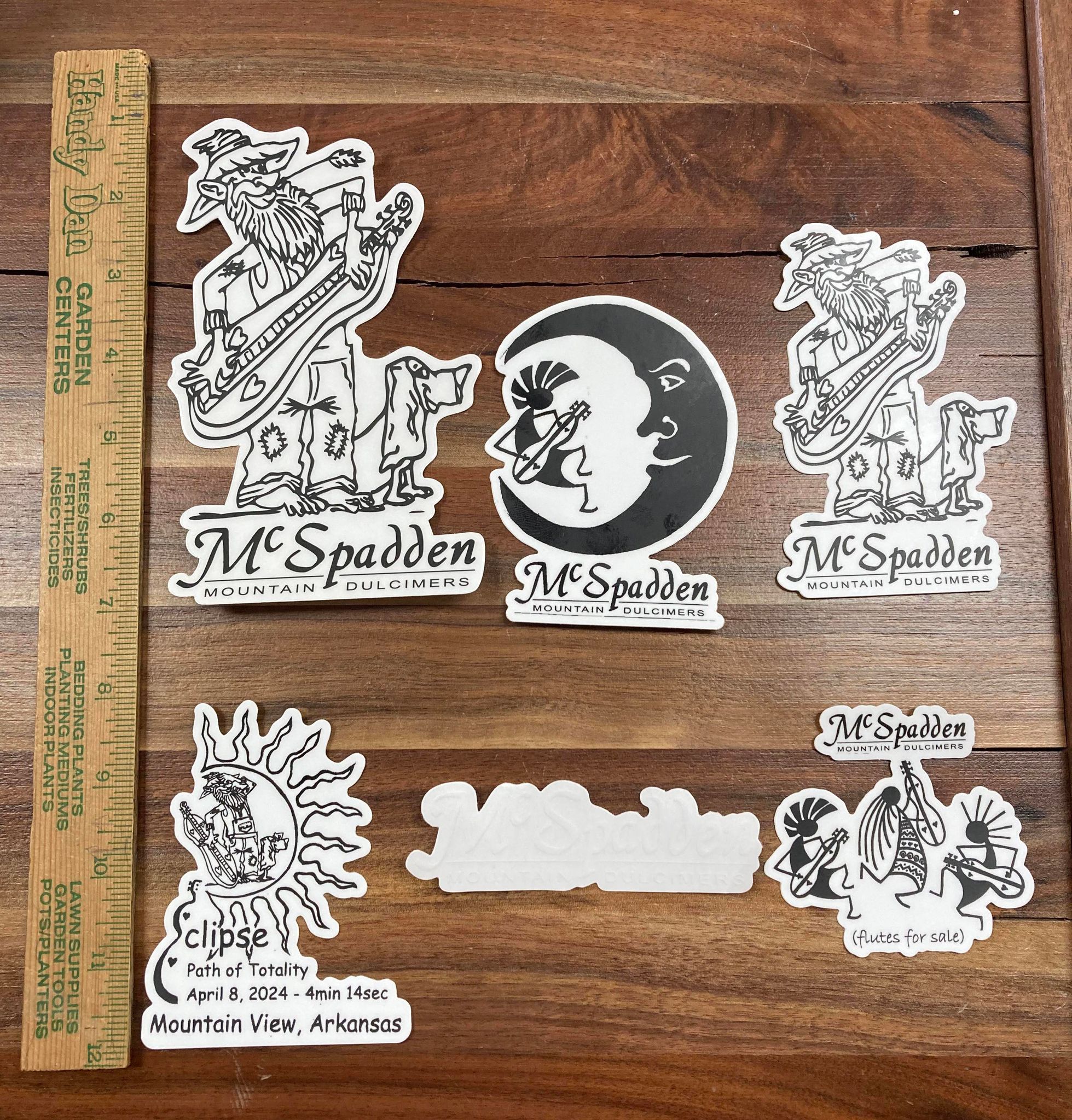 Collection of McSpadden Stickers for decorating and a wooden ruler on a table, offering fun to any creative project.
