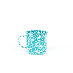 The Splatter Enamelware 16 oz Large Mug in teal and white speckled design, featuring a convenient handle, is perfect for your favorite beverages and beautifully showcased against a white background.