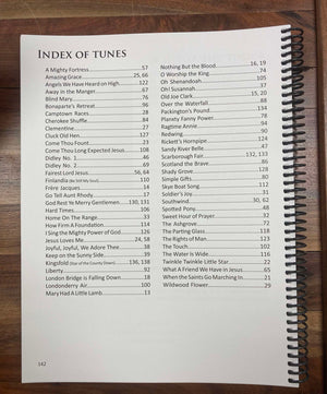 Spiral-bound book open to a page titled "Index of Tunes," showcasing song titles and corresponding page numbers, perfect for enthusiasts of the mountain dulcimer and those exploring D-A-D-D tuning, featured in "The Essential Four String Dulcimer" by Mark Tindle.