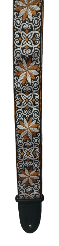 The Tan Hootenanny Guitar Strap features a black base with detailed white and brown geometric and floral patterns, offering a classic decorative style.